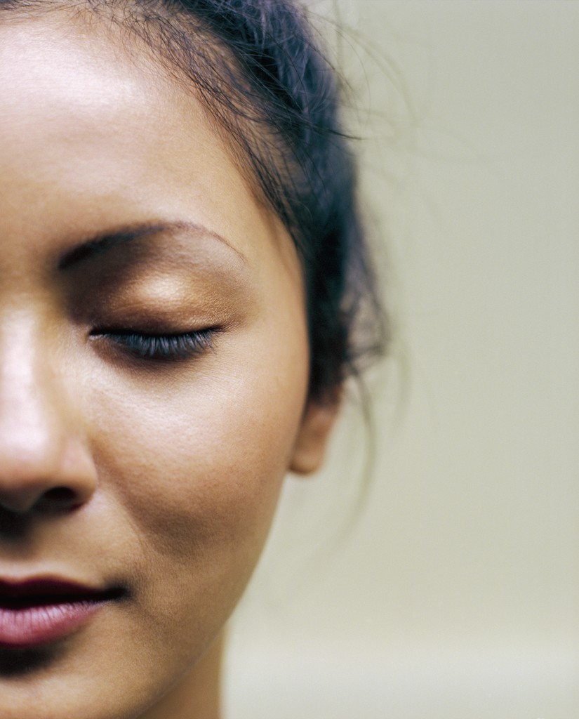 Picture of a a woman's face, with eyes closed in thought