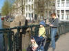 Family on a bridge over a canal being watched by a creepy bridge creature