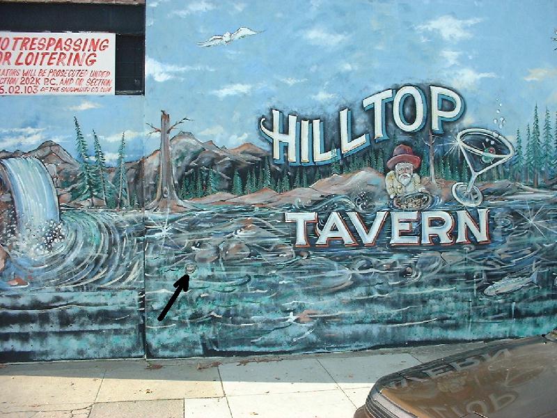 A photo of a benchmark on the wall of the Hilltop Tavern at the
   corner of 48th and J St. in Sacramento, CA